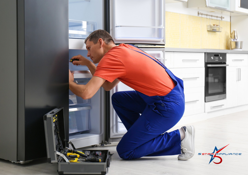  Professional appliance repair technician servicing a refrigerator for annual maintenance